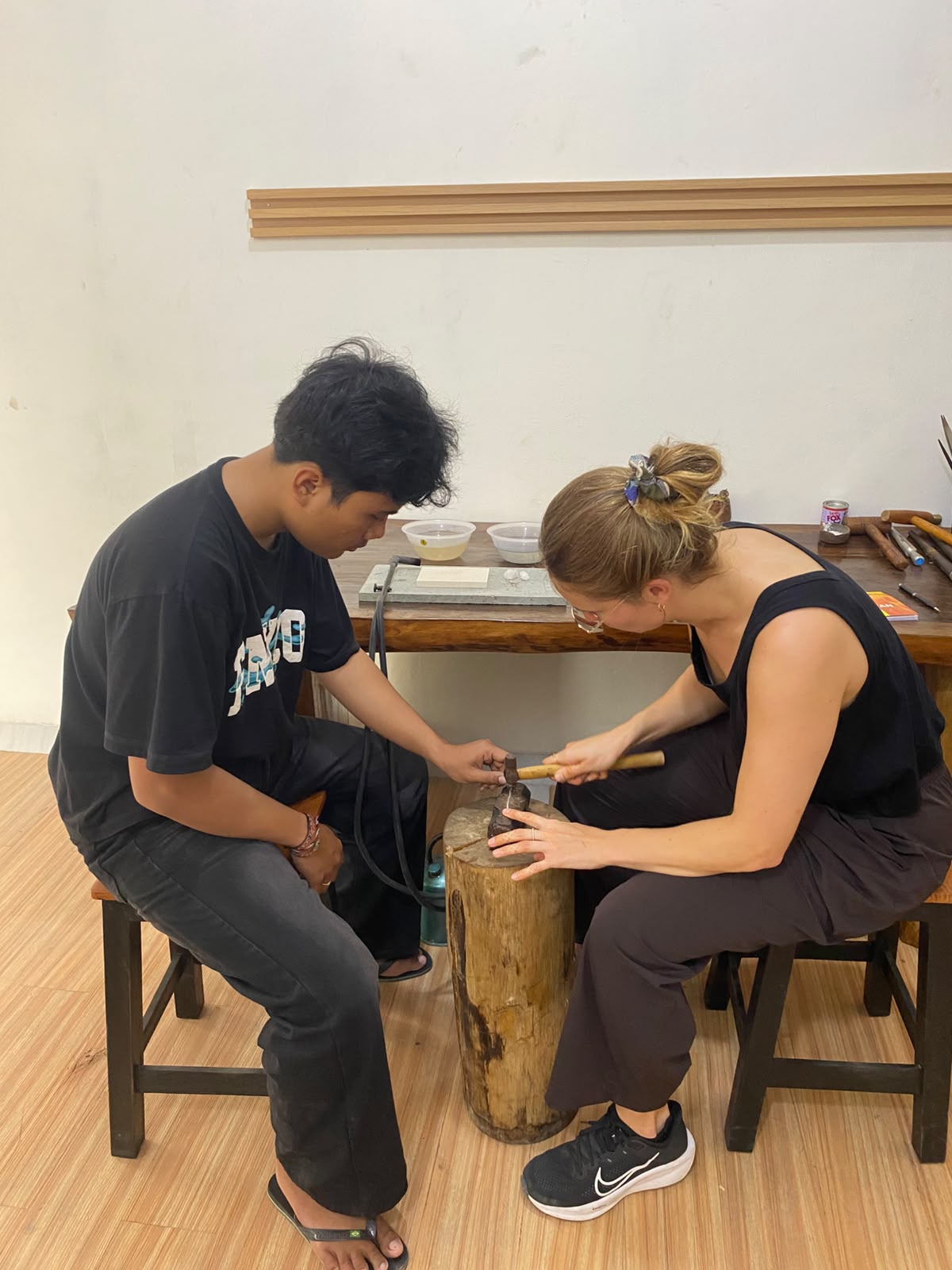 A participant shaping silver with help at the Sanur workshop