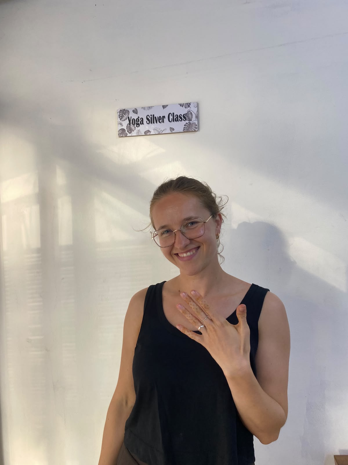 A smiling participant showing her finished ring